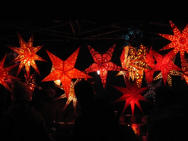 Glowing red christmas stars in the dark — Stock Photo, Image
