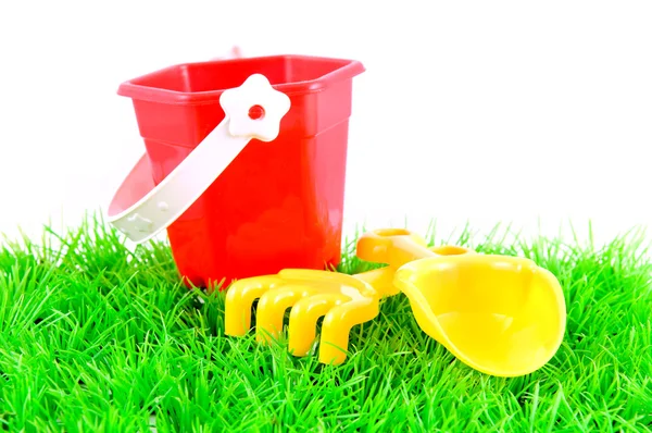 Песочница игрушки на зеленой траве Стоковая Картинка
