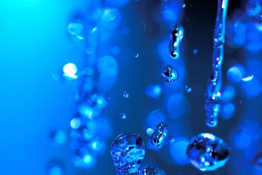 Big drops of water over blue background clipart