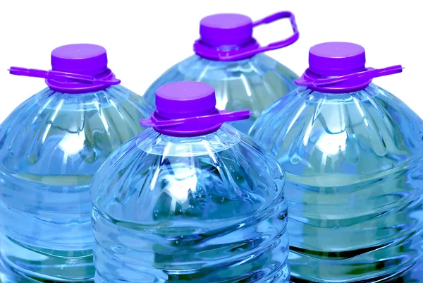 Cuatro botellas de agua aisladas —  Fotos de Stock