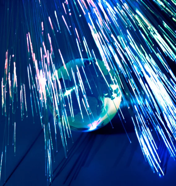 Fibers lights speeding around earth — Stock Photo, Image