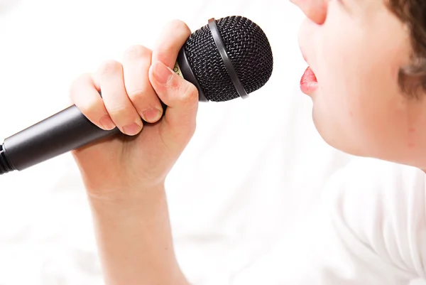 Black microphone in a hand — Stock Photo, Image
