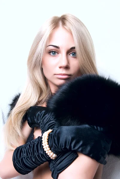 Een blond meisje in zwarte handschoenen — Stockfoto