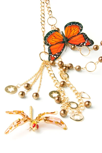 Золотий бісер з метеликом — стокове фото