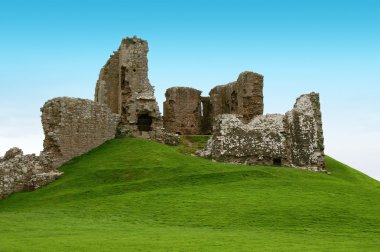 Ancient ruins on a green hill clipart