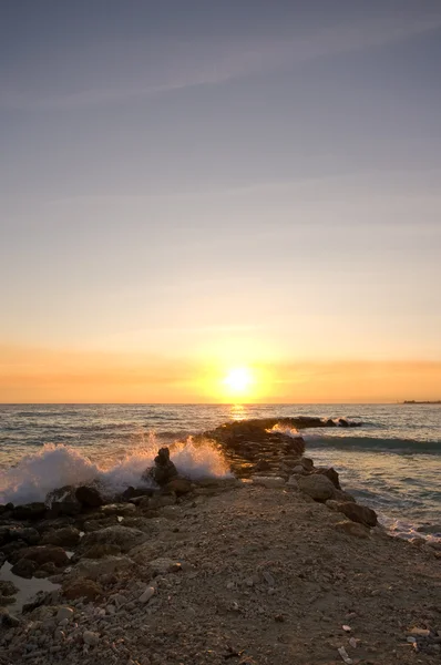 Wave breaker sunset — Stockfoto