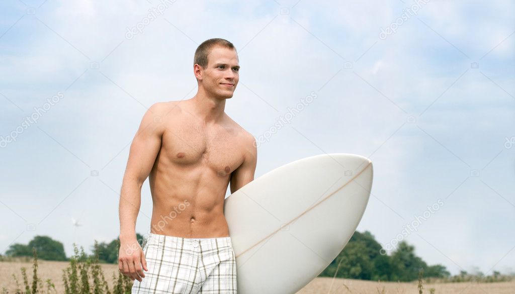 Handsome Surfer on the way to the beach