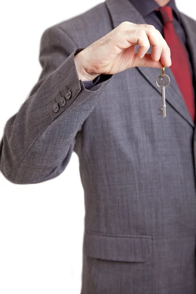 Man in suit holding key — Stock Photo, Image