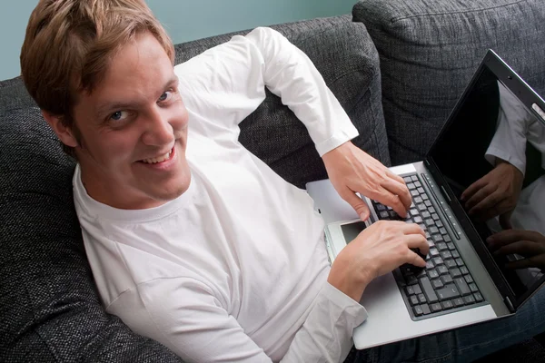 Man working on laptop at home Stock Photo