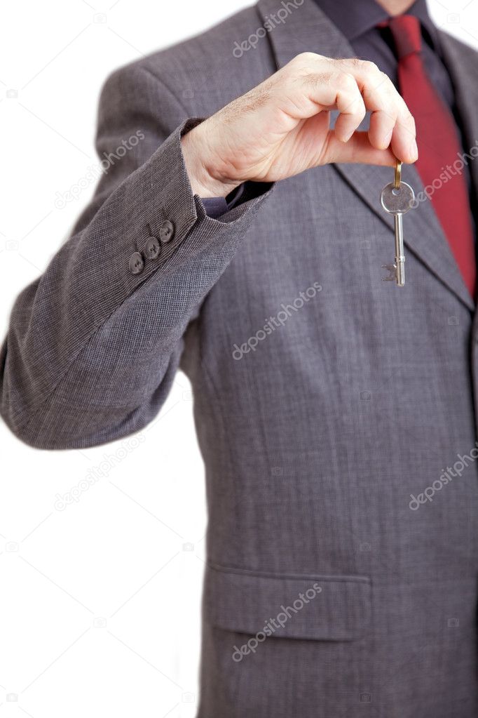 Man in suit holding key