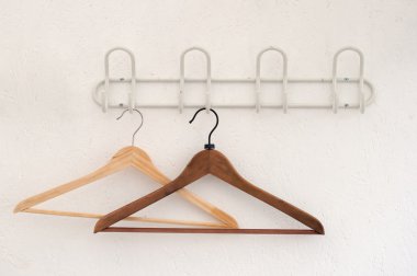 Pair of coathangers on the wall clipart