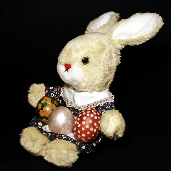 Bunny doll with three easter eggs — Stock Photo, Image