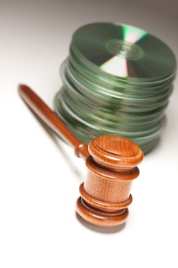 Stack of CD Rom or DVD Discs and Gavel clipart