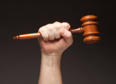 Male Fist Holding Wooden Gavel clipart