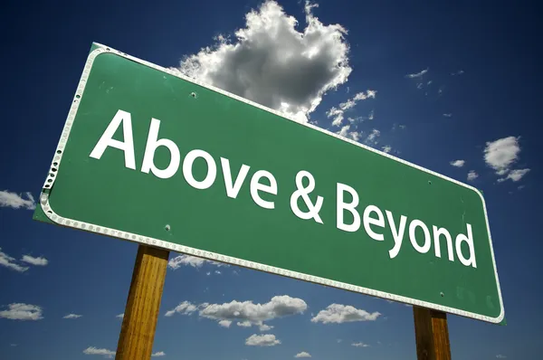 Above and Beyond Green Road Sign — Stock Photo, Image