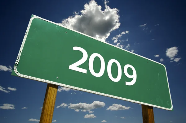 2009 Road Sign with dramatic clouds — Stock Photo, Image