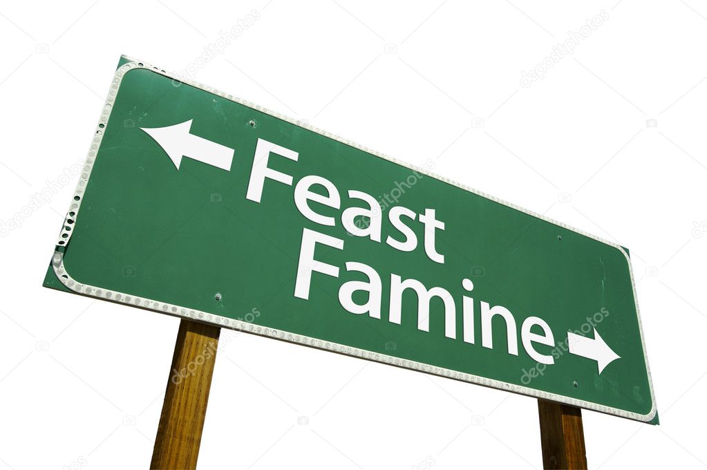 Feast Famine Green Road Sign on White