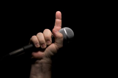 Man Holding Microphone in Fist clipart