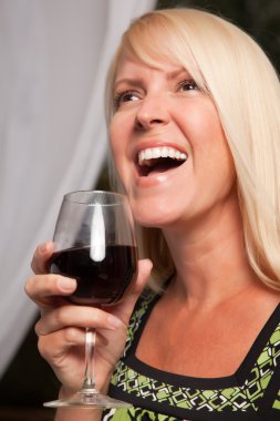 Beautiful blonde woman socializing at Party clipart