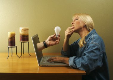 Lightbulb Coming Out of Screen to Woman clipart