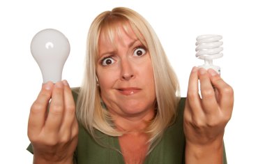Confused Blonde Holds Energy Saving Lightbulb