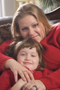 Young Mother and Daughter Embrace clipart