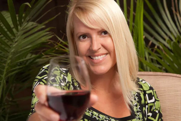 Beautiful blonde Toasts with red wine — Stock Photo, Image