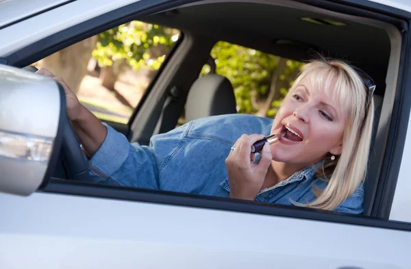 Flicka gäller läppstift under körning — Stockfoto