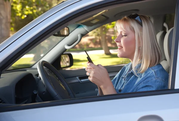 Vrouw voor SMS-berichten tijdens het rijden — Stockfoto