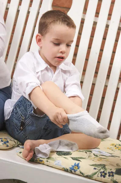 穿衣服的可爱小男孩把他的袜子 — 图库照片