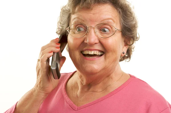 Mujer mayor sonriente usando teléfono celular en blanco —  Fotos de Stock