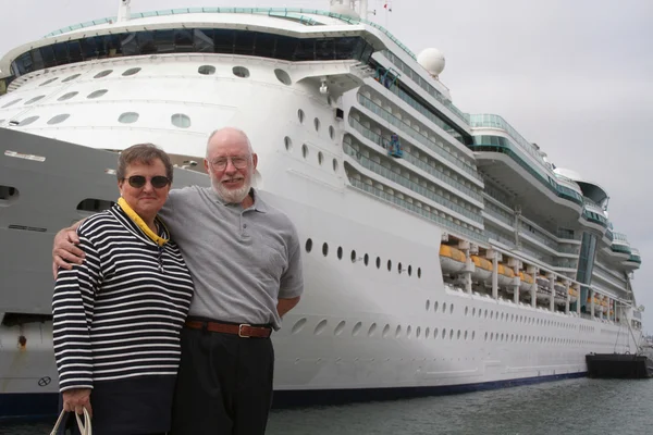 Seniorenpaar vor Kreuzfahrtschiff — Stockfoto