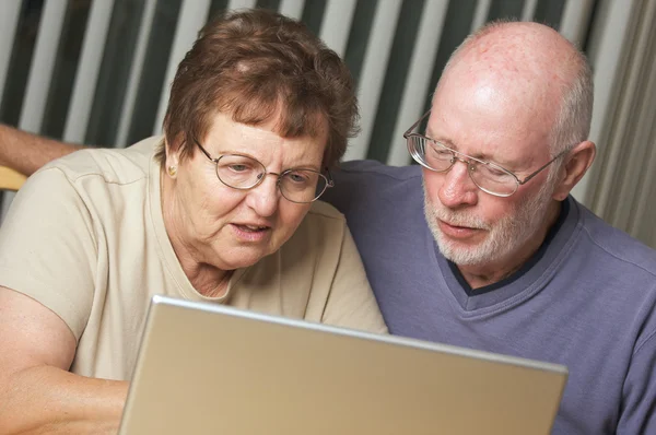Adultos mayores trabajando en un ordenador portátil — Foto de Stock