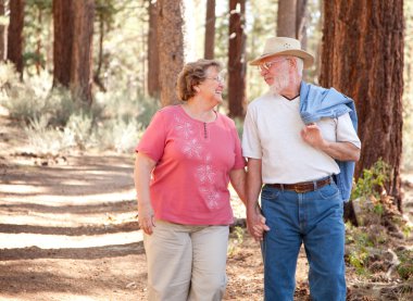 Loving Senior Couple Walking Outdoors clipart