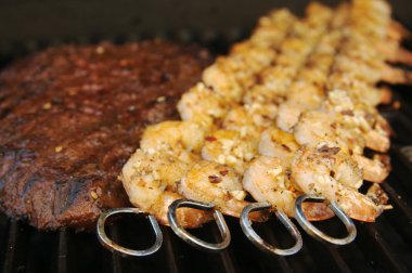 Succulent Steak and Shrimp on BBQ clipart