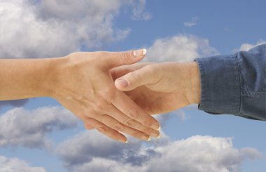 Man and Woman Shaking Hands Over Clouds clipart