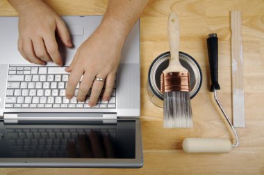 Handyman Using Laptop Overhead Image clipart