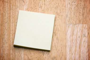 Post It Note Pad on a Wood Background