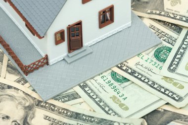 Model House Resting on Money clipart