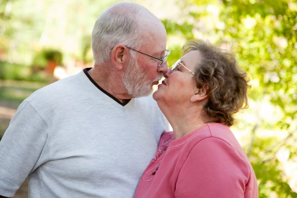 Starszy miłości para całuje i cieszyć się na zewnątrz — Zdjęcie stockowe