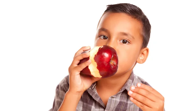 Lindo chico hispano comiendo manzana roja grande —  Fotos de Stock