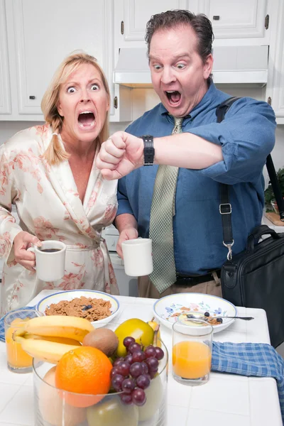 Stressed Couple Eating, Looking at Time — Stock Photo, Image