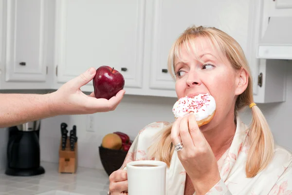 Woman in Kitchen with Fruit and Donuts — Stock Photo, Image