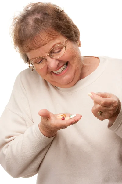 Aantrekkelijke senior vrouw nemen van pillen geïsoleerd — Stockfoto