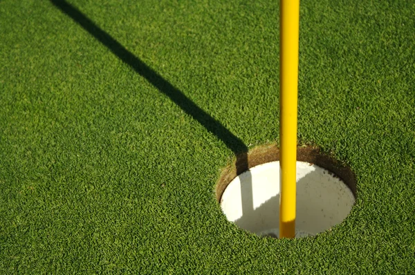 Frodiga, färska mejade golf gröna och flagga — Stockfoto