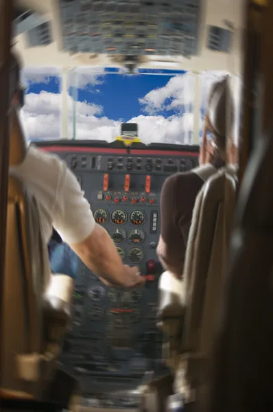Реактивный самолет с пилотами и облаками — стоковое фото