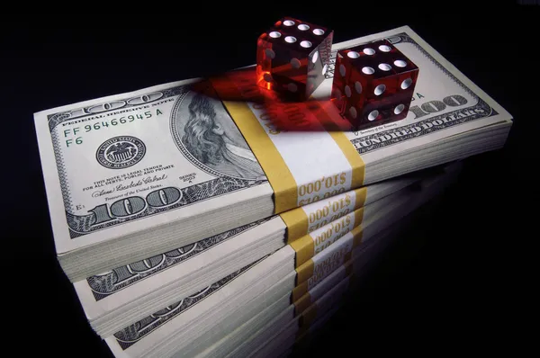 Stacks of Money and Red Dice on Black — Stock Photo, Image
