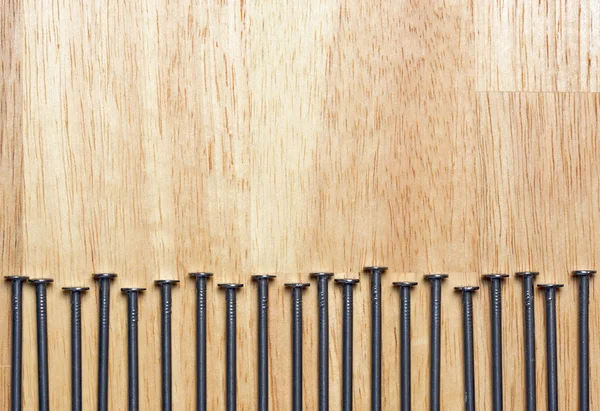 Makro von Nägeln auf einem Holzhintergrund. — Stockfoto
