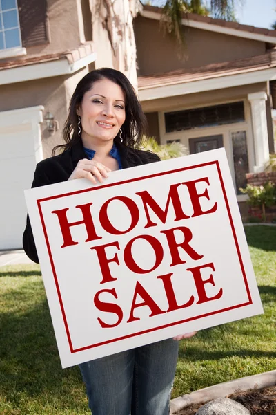 Hispanic Woman Holds Home For Sale Sign — Stock Photo, Image