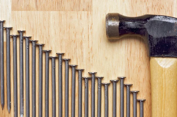 Hammer and Declining Graph of Nails — Stock Photo, Image
